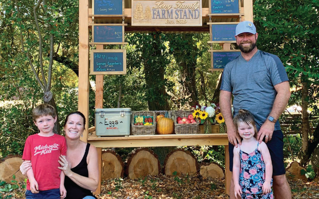 family in front of farmstand